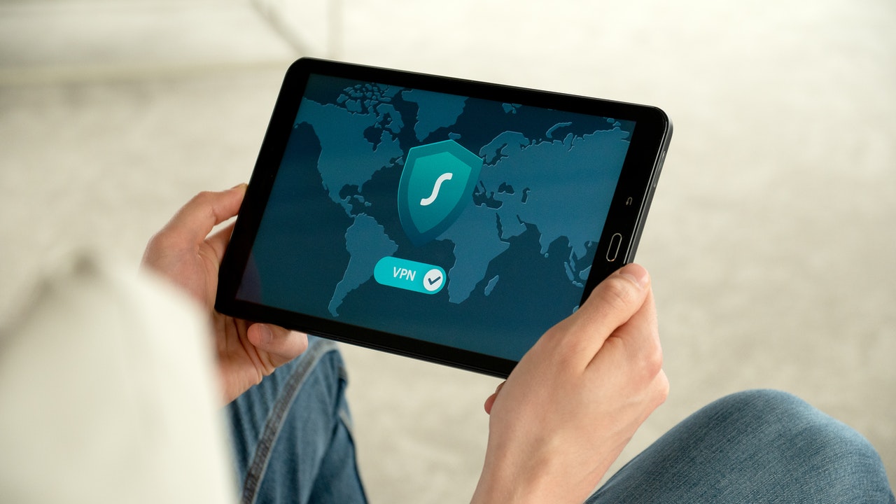 Person checking a VPN security app on a tablet