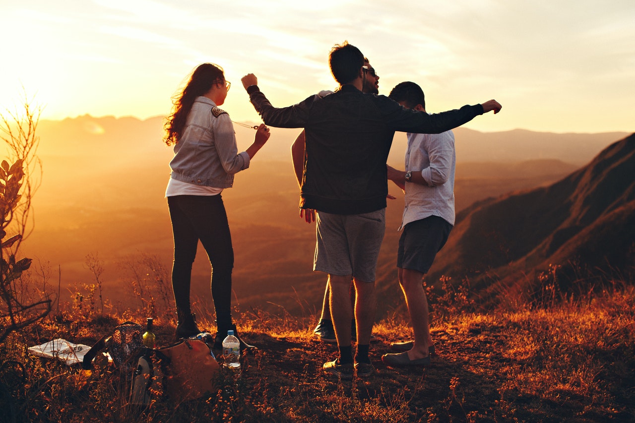 Family celebrating together outdoors at sunset